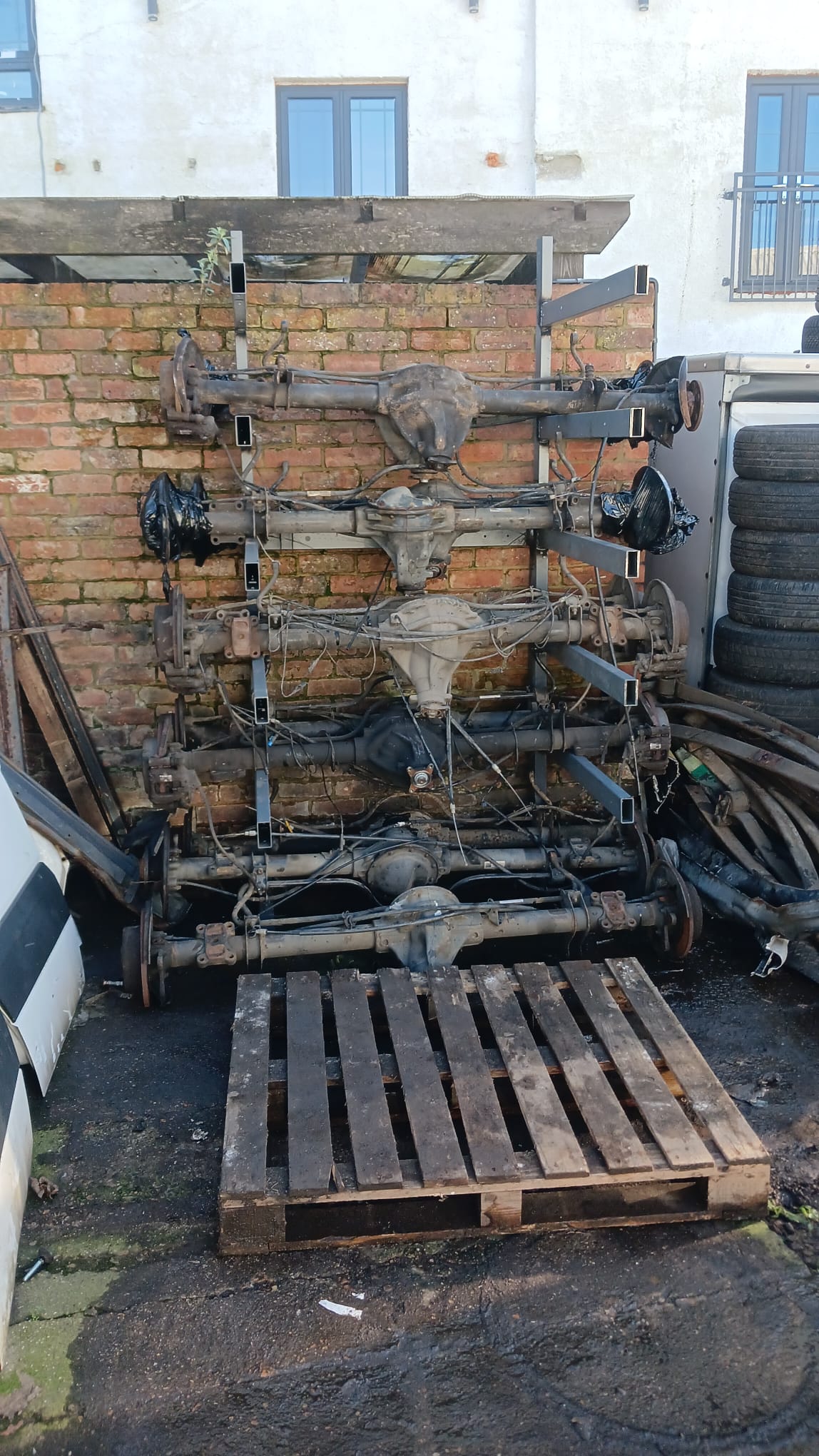 Used axles and suspension parts on a pallet