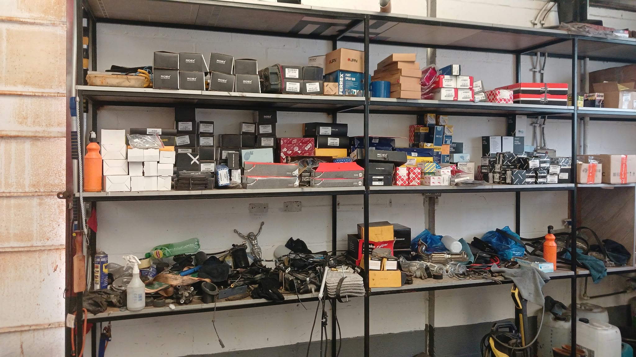 Boxed used parts arranged on steel shelving